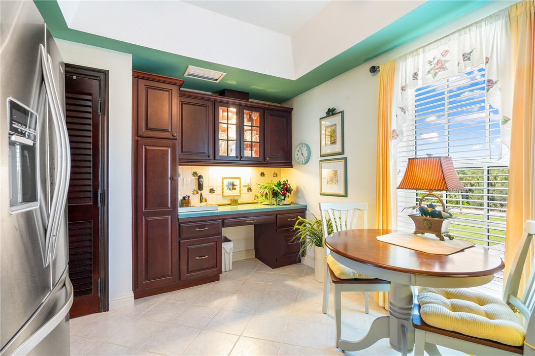 650 Beach Road, Unit 245 Vero Beach, FL 32963 - Photo 23 of 32 a view of a dining room with furniture a kitchen and chandelier