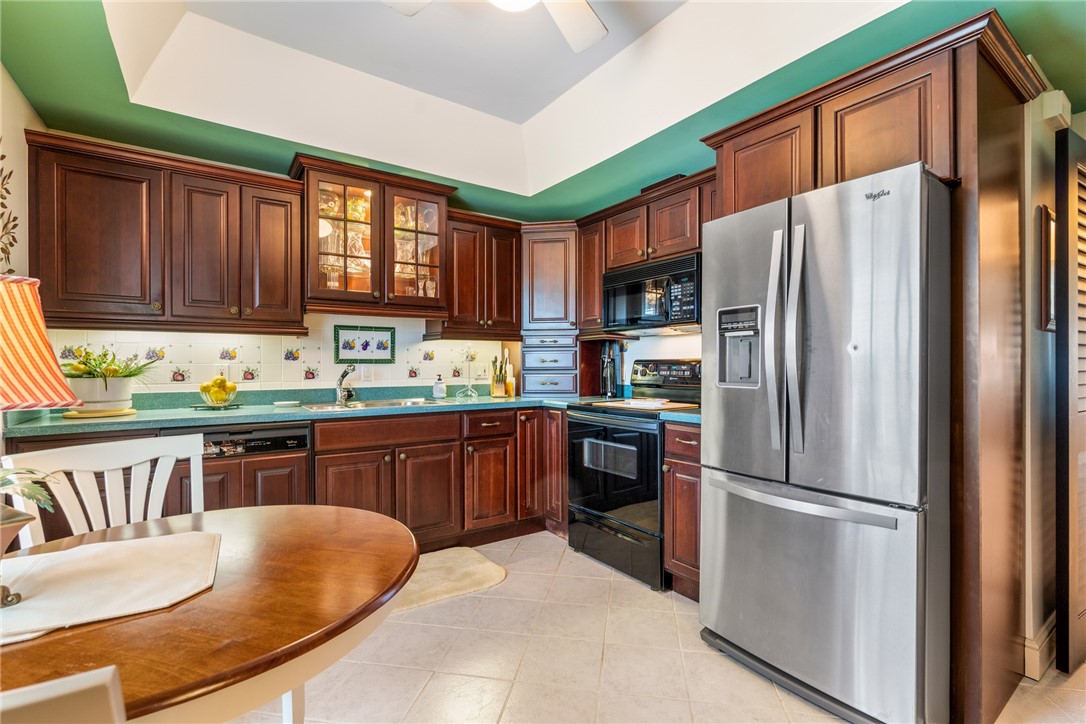650 Beach Road, Unit 245 Vero Beach, FL 32963 - Photo 26 of 32 a kitchen with stainless steel appliances granite countertop a refrigerator stove top oven and sink
