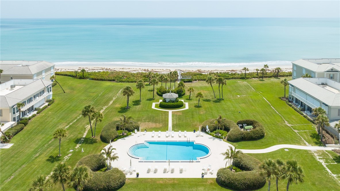 650 Beach Road, Unit 245 Vero Beach, FL 32963 - Photo 6 of 32 a bathroom with a table and a chair