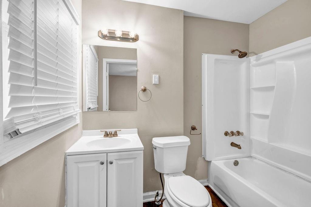 245 Bromack Drive Southeast Atlanta, GA 30315 - Photo 12 of 16 a bathroom with a sink a toilet and shower