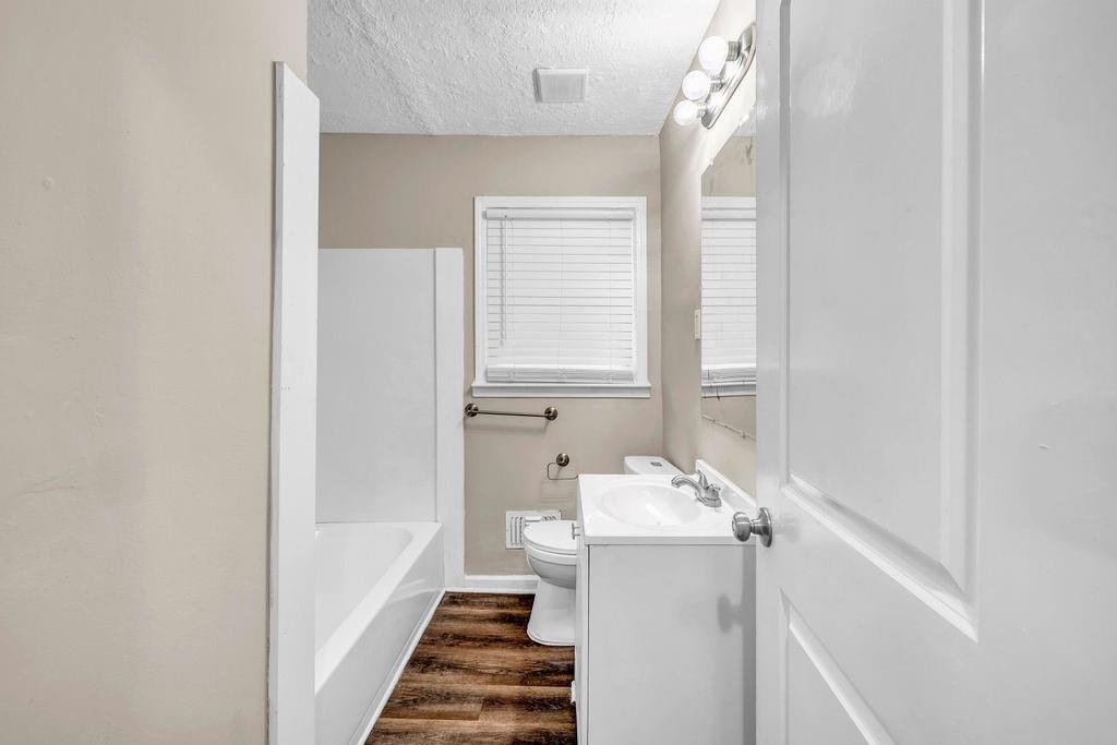 245 Bromack Drive Southeast Atlanta, GA 30315 - Photo 13 of 16 a bathroom with a sink a mirror and a bathtub