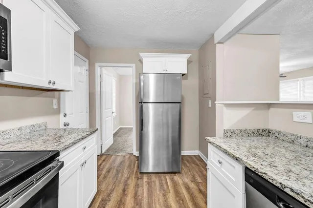 a kitchen with a refrigerator and countertop