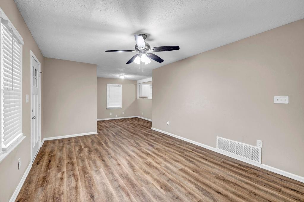 245 Bromack Drive Southeast Atlanta, GA 30315 - Photo 7 of 16 a view of empty room with wooden floor and fan