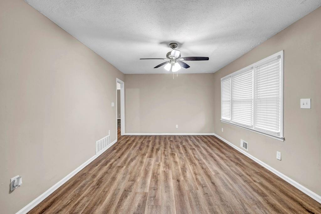245 Bromack Drive Southeast Atlanta, GA 30315 - Photo 8 of 16 wooden floor in an empty room with a window