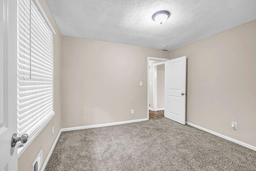 245 Bromack Drive Southeast Atlanta, GA 30315 - Photo 9 of 16 an empty room with windows and closet