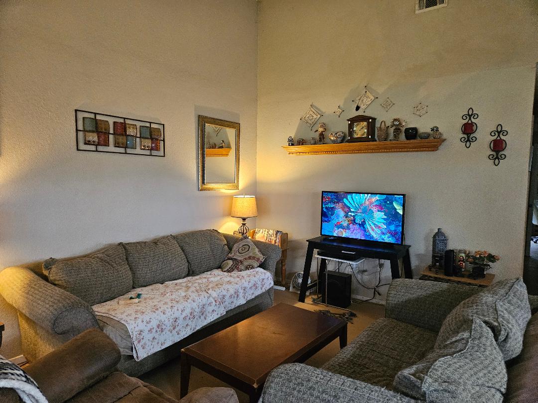 817 Lexington Road Elgin, TX 78621 - Photo 14 of 20 a living room with furniture and a flat screen tv