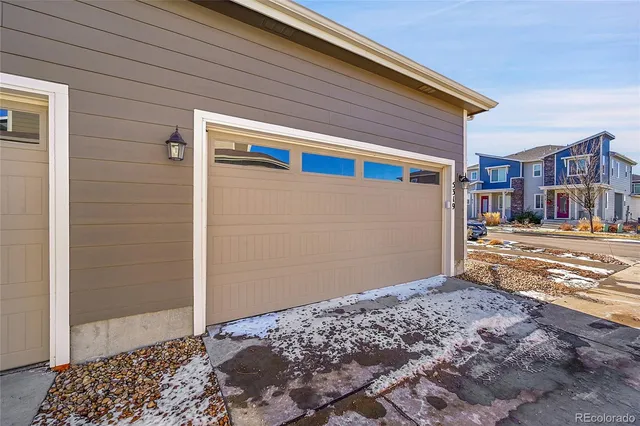 a view of a house with a snow on the road