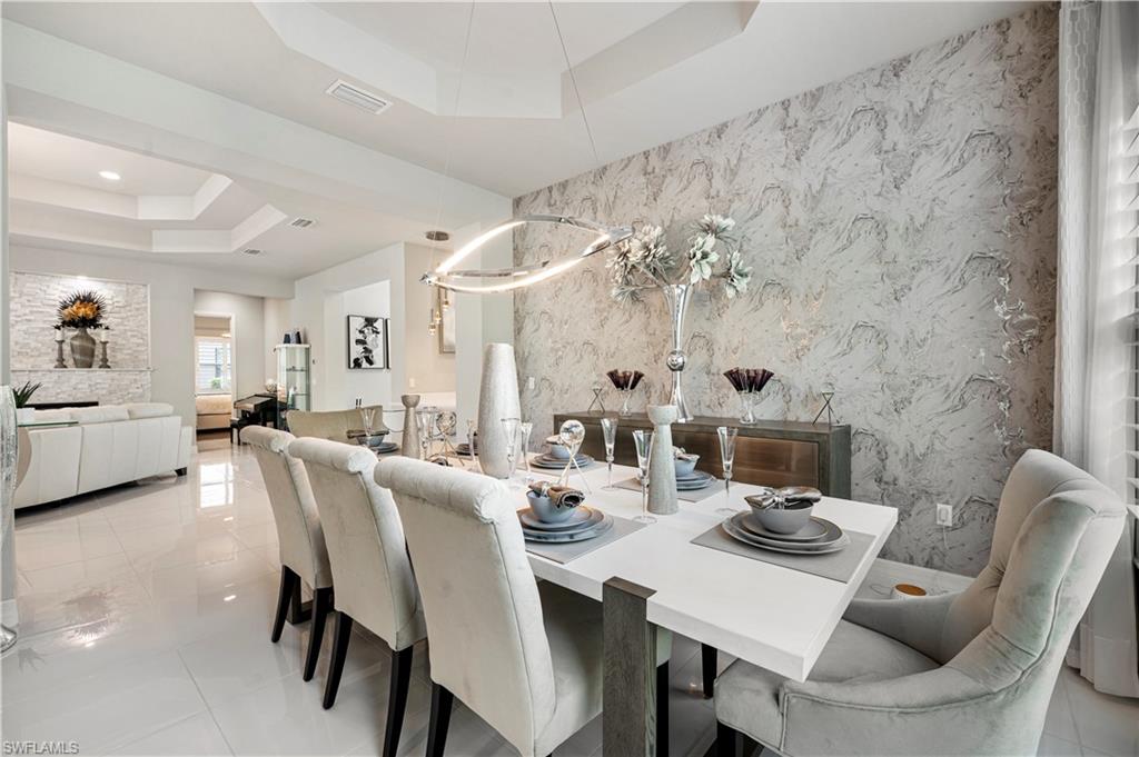 4462 Caldera Circle Naples, FL 34119 - Photo 11 of 33 a view of a dining room with furniture and a chandelier