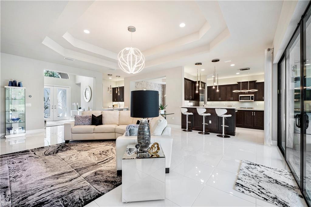 4462 Caldera Circle Naples, FL 34119 - Photo 12 of 33 a living room with furniture kitchen view and a large window