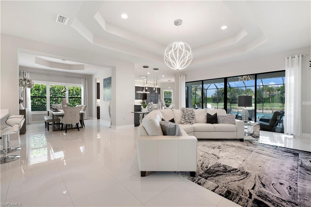 4462 Caldera Circle Naples, FL 34119 - Photo 13 of 33 a living room with furniture dining table and a large window