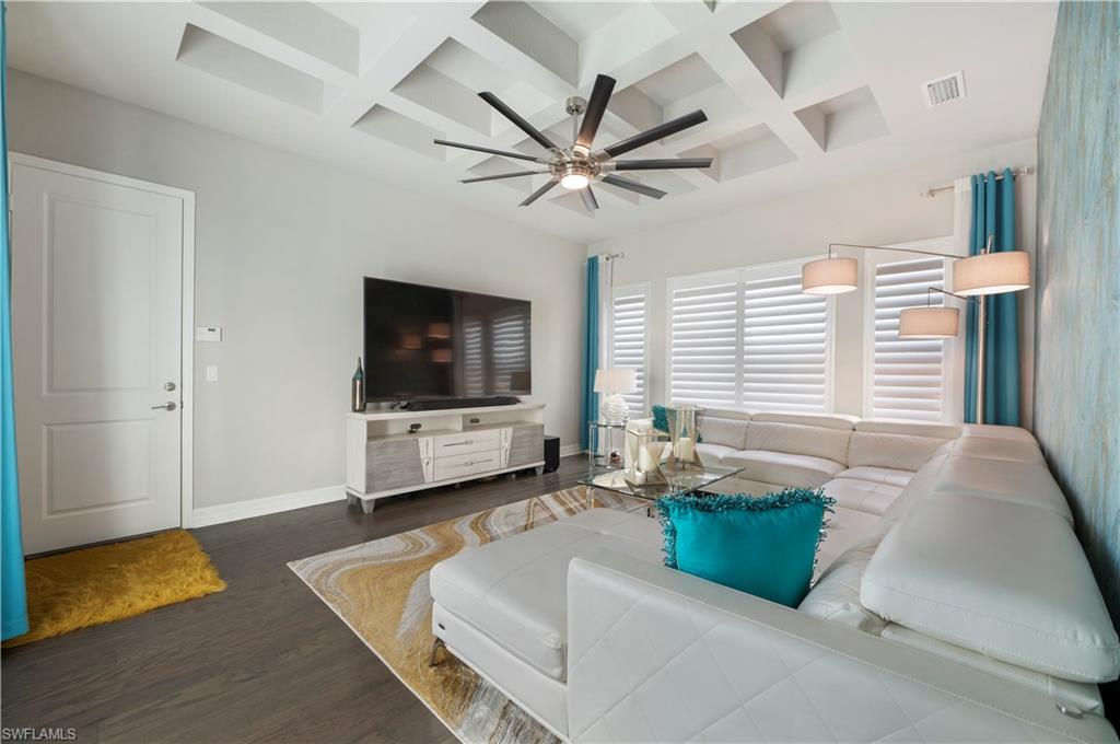 4462 Caldera Circle Naples, FL 34119 - Photo 17 of 33 a living room with furniture and a flat screen tv