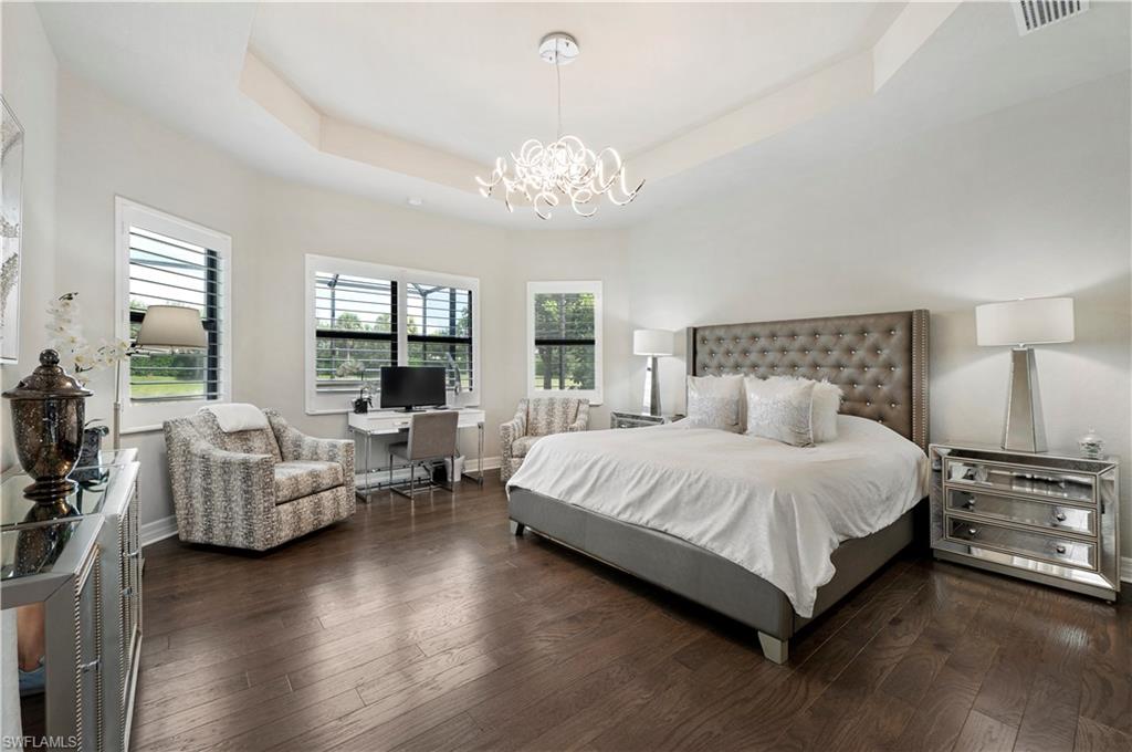 4462 Caldera Circle Naples, FL 34119 - Photo 18 of 33 a spacious bedroom with a bed and a couch