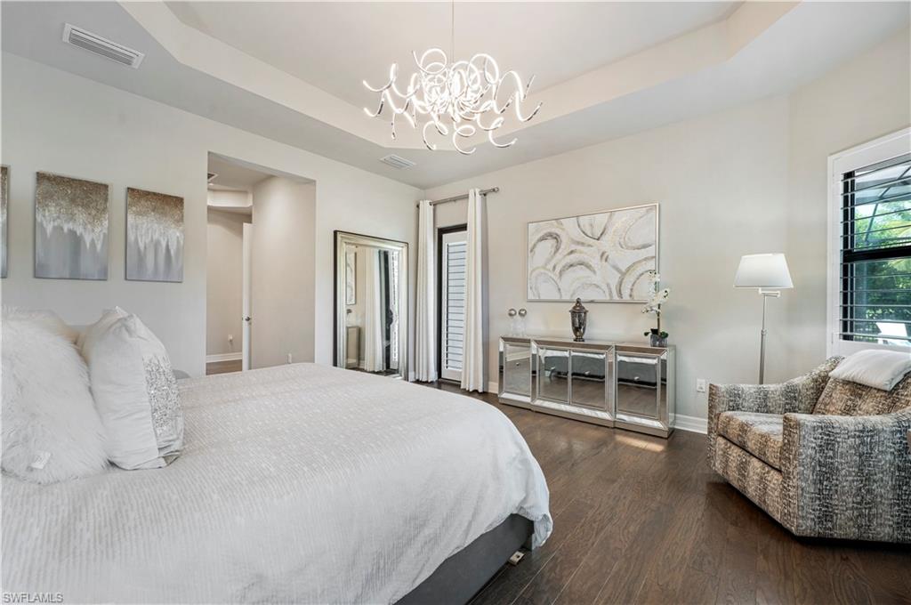4462 Caldera Circle Naples, FL 34119 - Photo 19 of 33 a spacious bedroom with a bed and furniture