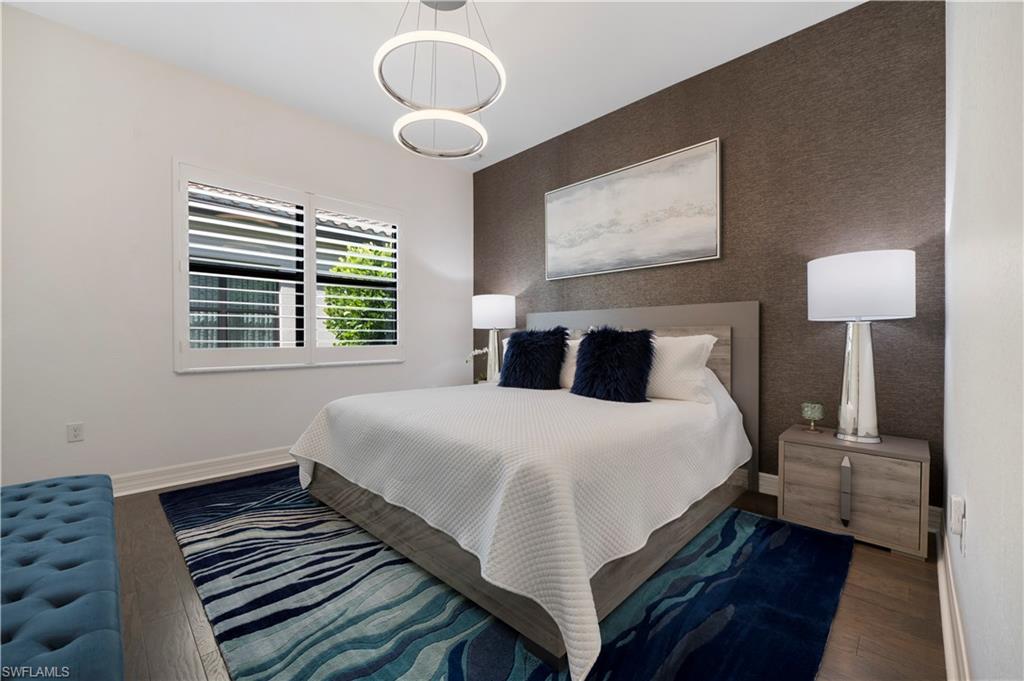 4462 Caldera Circle Naples, FL 34119 - Photo 21 of 33 a bedroom with bed and wooden floor