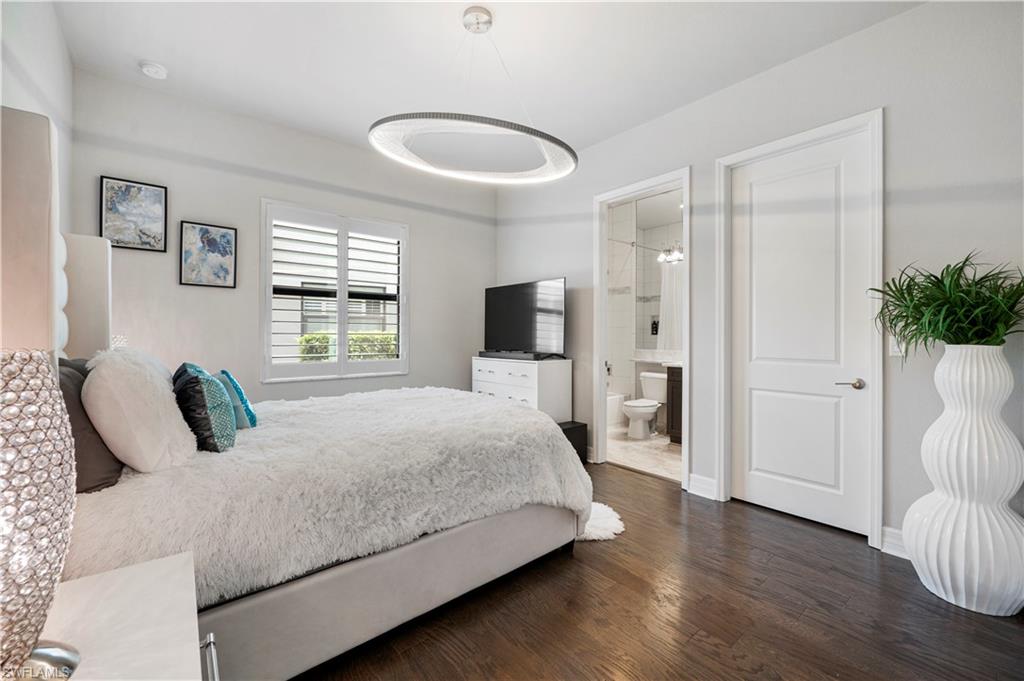 4462 Caldera Circle Naples, FL 34119 - Photo 23 of 33 a bedroom with a large bed and a flat screen tv