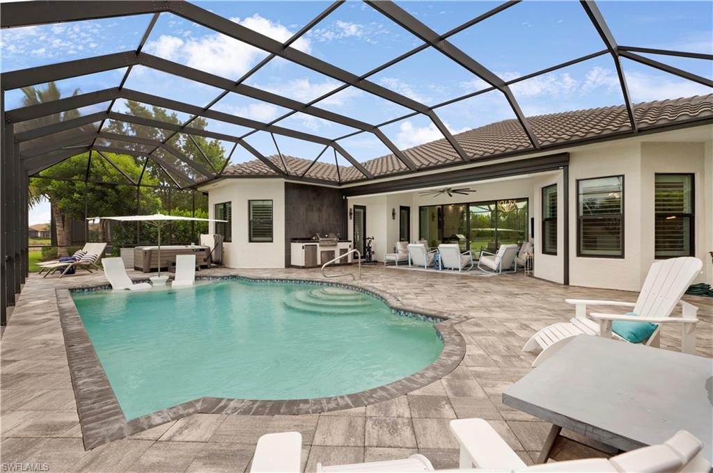 4462 Caldera Circle Naples, FL 34119 - Photo 25 of 33 a view of a swimming pool with a patio
