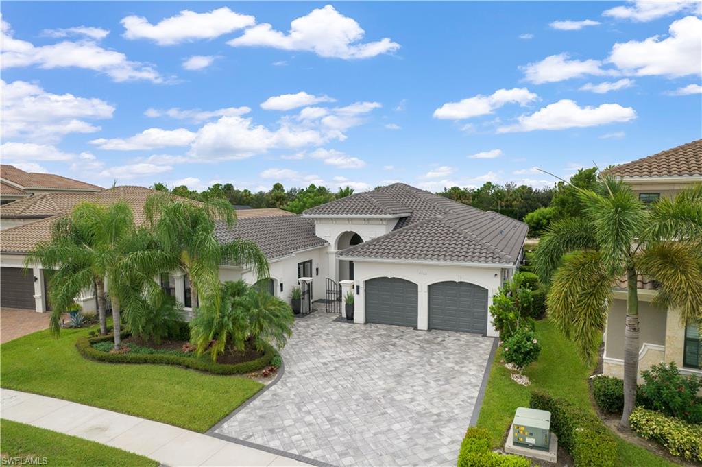 4462 Caldera Circle Naples, FL 34119 - Photo 29 of 33 a front view of a house with a garden