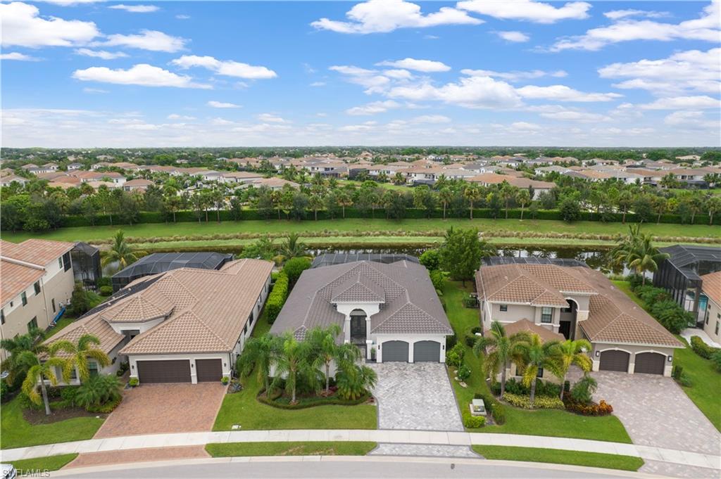 4462 Caldera Circle Naples, FL 34119 - Photo 32 of 33 an aerial view of a house with outdoor space and lake view