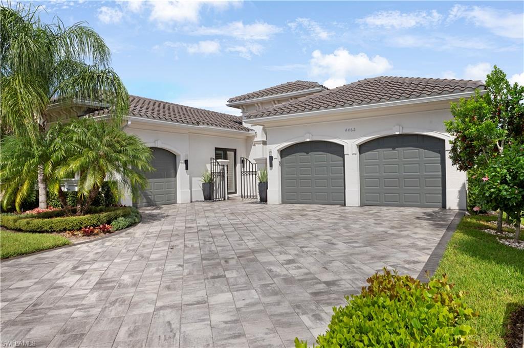 4462 Caldera Circle Naples, FL 34119 - Photo 4 of 33 a view of a white house with a yard and plants