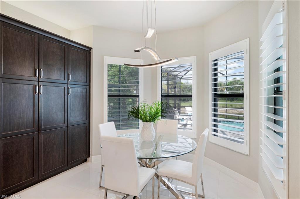 4462 Caldera Circle Naples, FL 34119 - Photo 10 of 33 a dining room with furniture and window