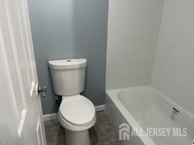 a bathroom with a toilet and a bathtub