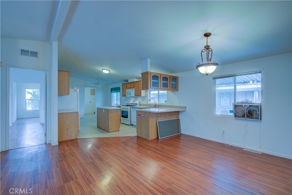 6450 North Winton Way, Unit 93 Winton, CA 95388 - Photo 12 of 51 a kitchen with kitchen island stainless steel appliances sink and wooden floor