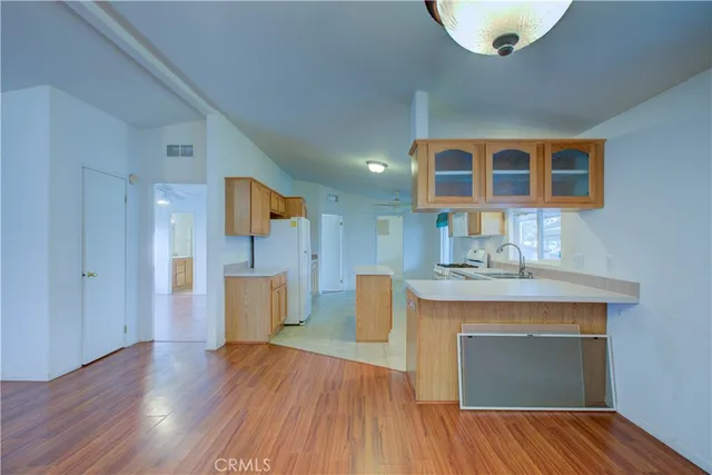 a view of a kitchen with a sink and a refrigerator