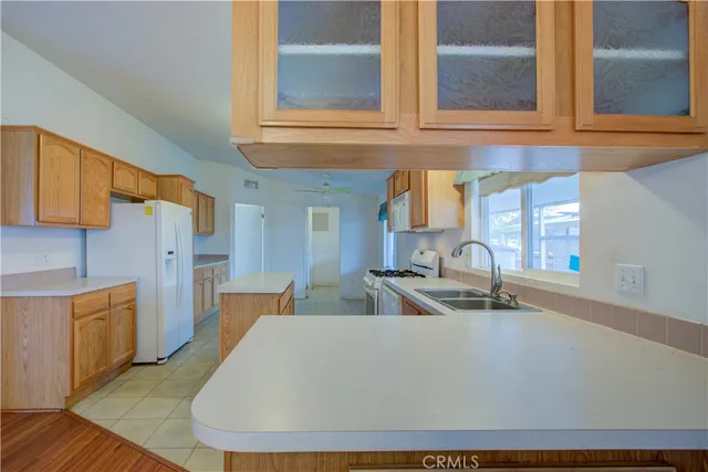 a kitchen with stainless steel appliances a sink a stove and a refrigerator