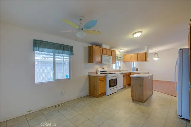 a kitchen with a stove a sink and a refrigerator