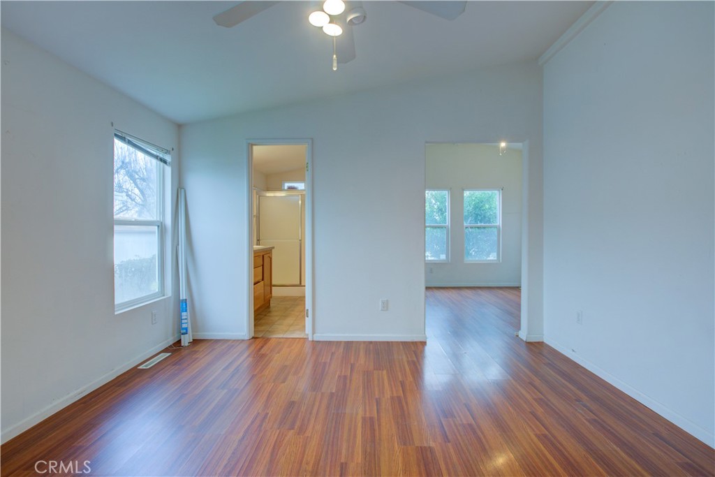 6450 North Winton Way, Unit 93 Winton, CA 95388 - Photo 27 of 51 an empty room with wooden floor and windows