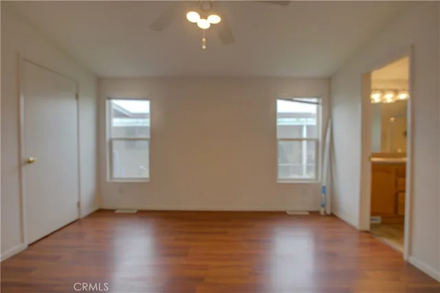 a view of an empty room and wooden floor