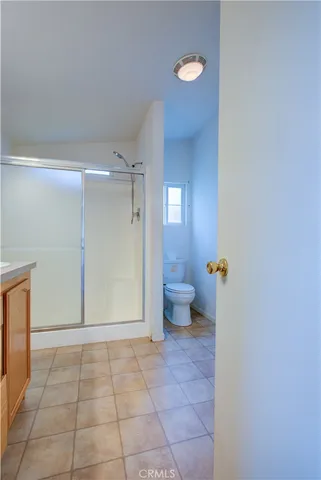 a bathroom with a sink a toilet and a shower
