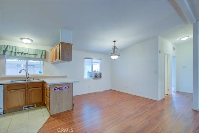 a view of a kitchen with a sink and wooden floor