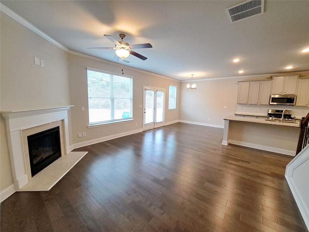 512 Hinton Farm Wy. Way Dacula, GA 30019 - Photo 12 of 30 a view of an empty room with wooden floor and a fireplace