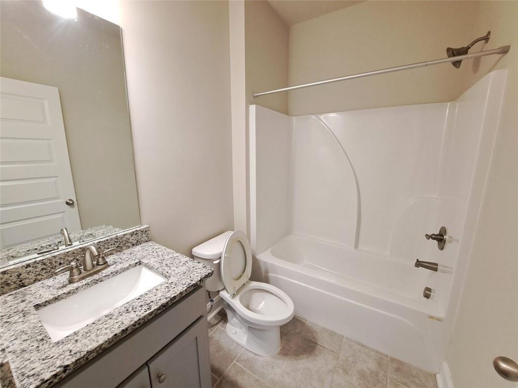 512 Hinton Farm Wy. Way Dacula, GA 30019 - Photo 17 of 30 a bathroom with a granite countertop sink toilet and shower