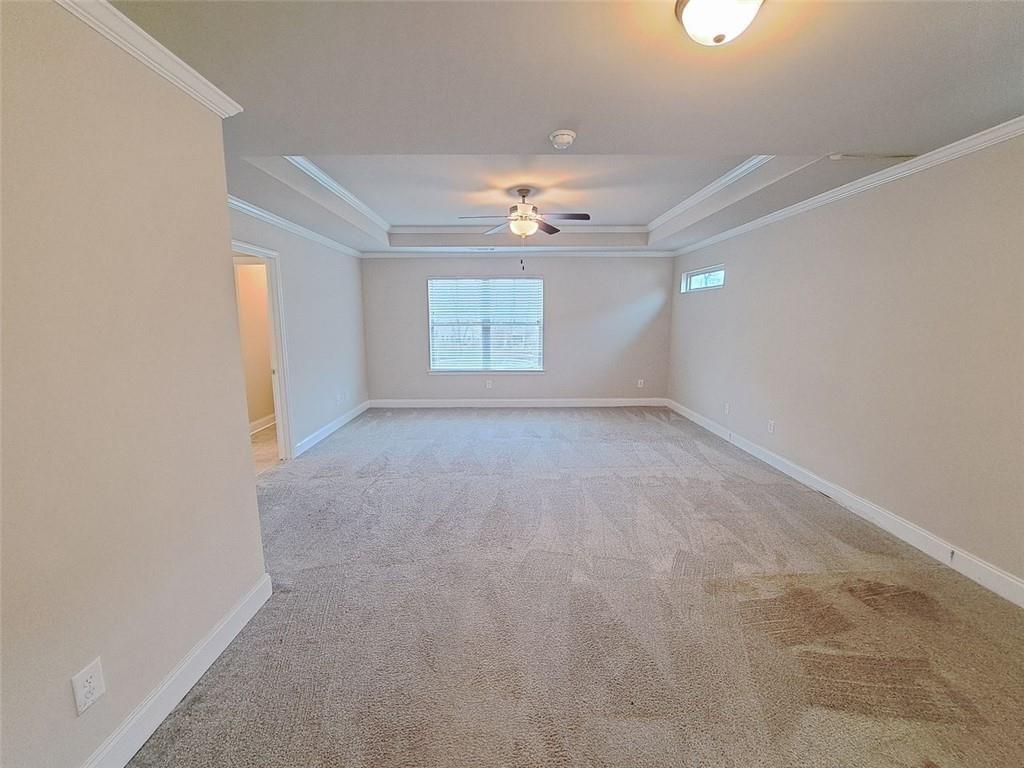 512 Hinton Farm Wy. Way Dacula, GA 30019 - Photo 20 of 30 an empty room with windows and chandelier fan