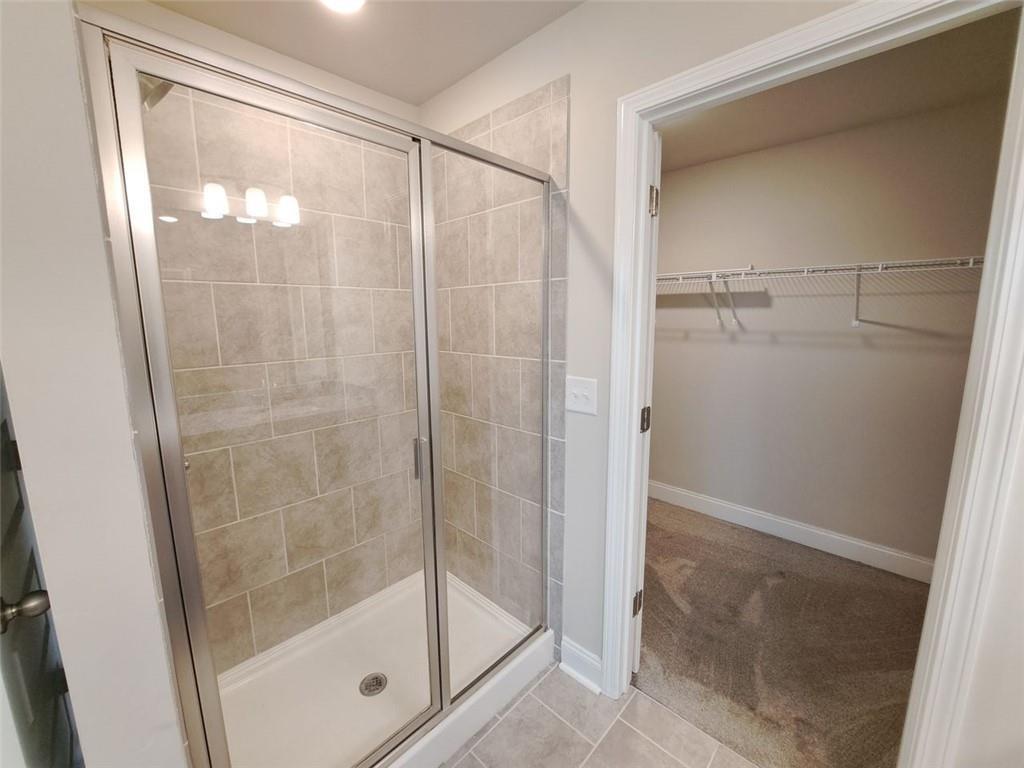 512 Hinton Farm Wy. Way Dacula, GA 30019 - Photo 24 of 30 a bathroom with a glass shower door
