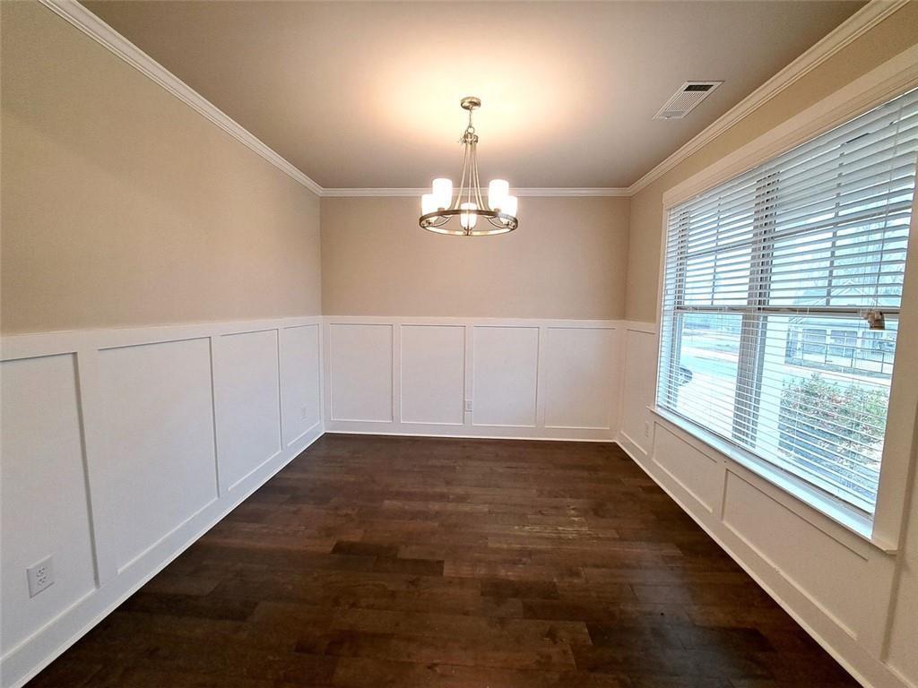 512 Hinton Farm Wy. Way Dacula, GA 30019 - Photo 5 of 30 an empty room with chandelier windows and wooden floor