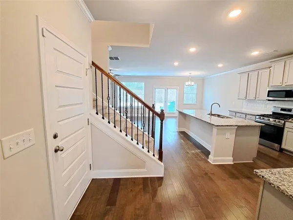 a view of kitchen with wooden floor and electronic appliances