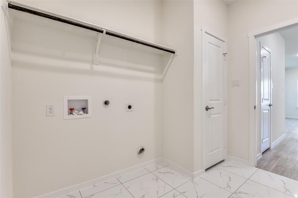 608 Southwest 3rd Street Kerens, TX 75144 - Photo 14 of 25 Laundry room featuring washer hookup, electric dryer hookup, light marble finish floors, and gas dryer hookup