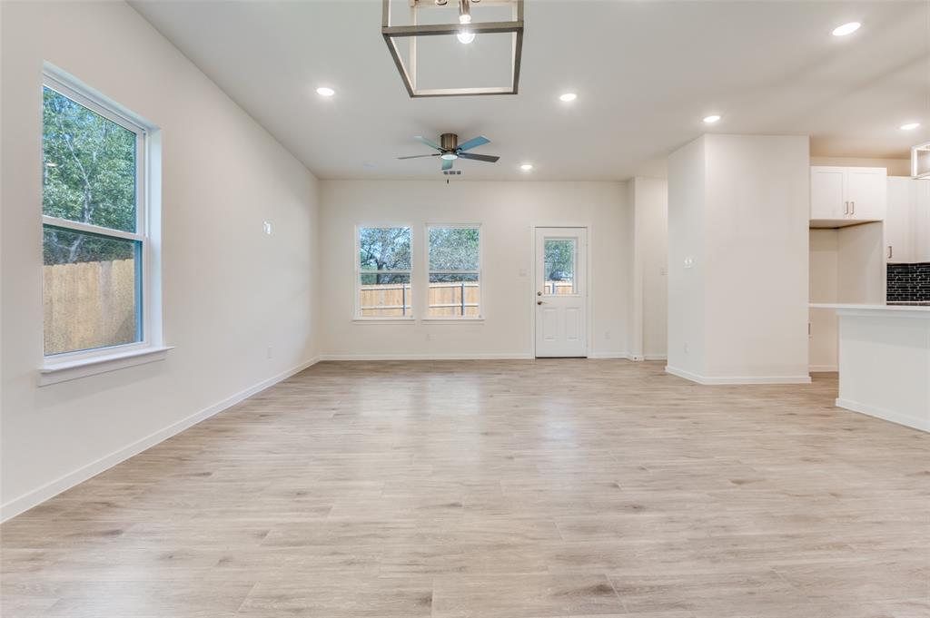 608 Southwest 3rd Street Kerens, TX 75144 - Photo 9 of 25 Unfurnished living room featuring recessed lighting, light wood-type flooring, and a ceiling fan