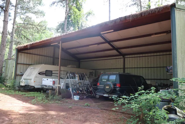 a backyard of a house with barbeque oven and outdoor seating