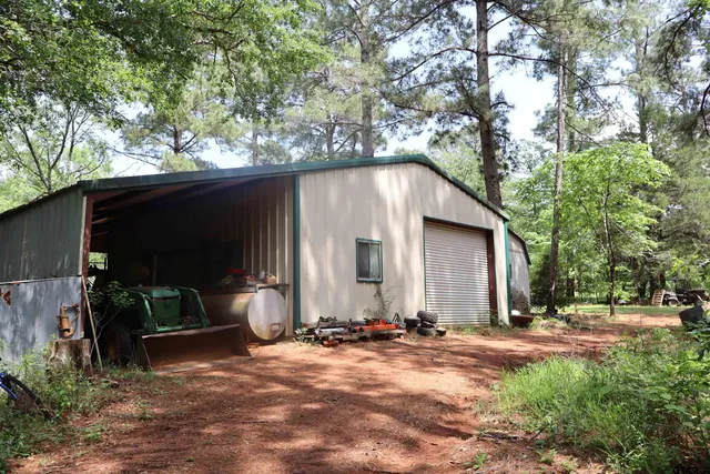 a view of a patio with table and chairs under an umbrella