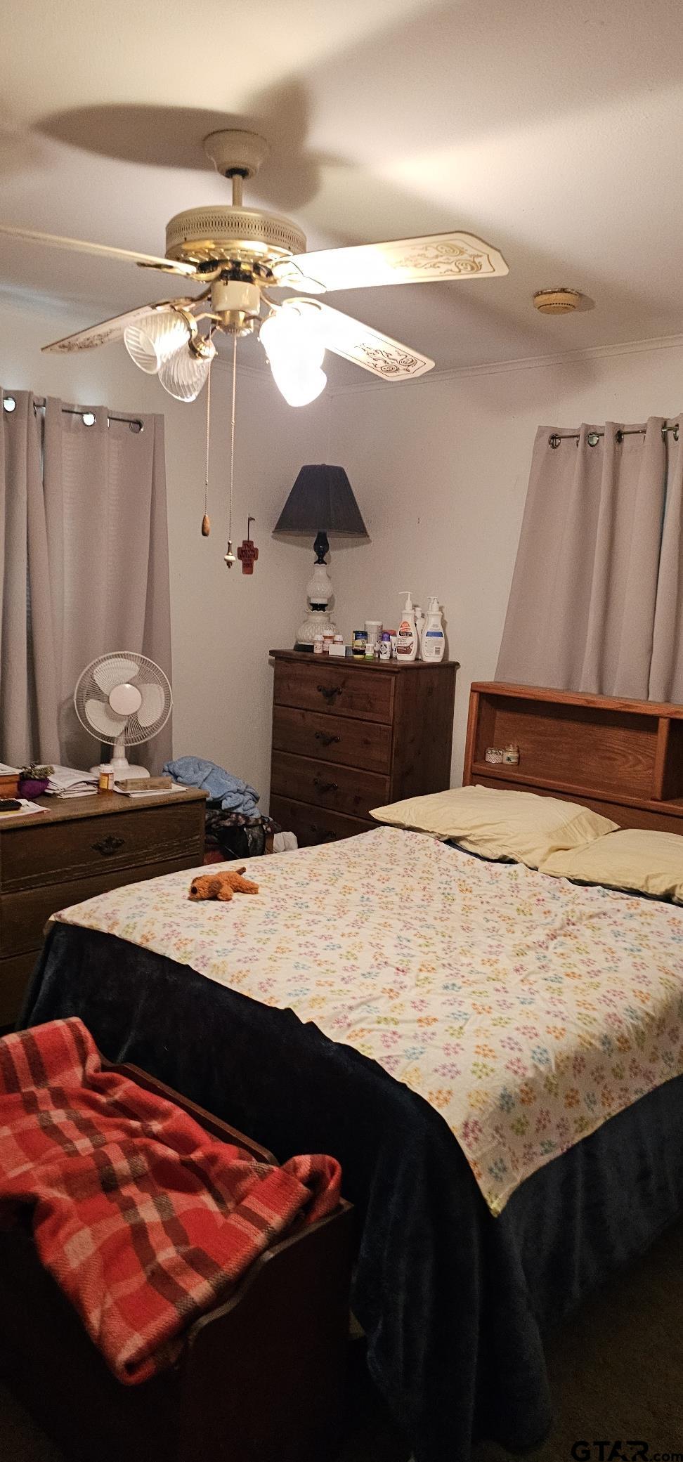 4269 Highway 21 Alto, TX 75925 - Photo 40 of 41 a bedroom with a bed and a chandelier