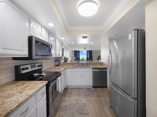 a kitchen with a sink stainless steel appliances and cabinets