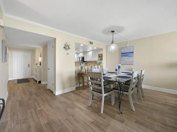 a view of a dining room with furniture and wooden floor