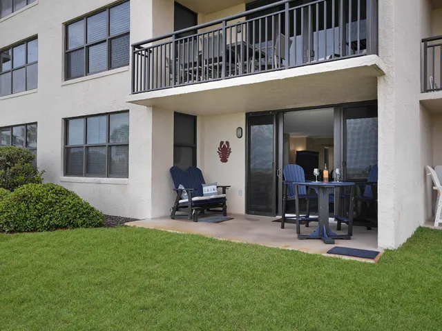 a view of a house with backyard porch and sitting area