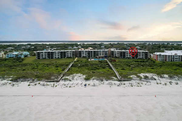 an aerial view of a houses with a yard