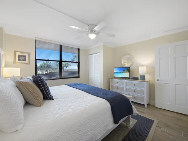 a bedroom with a large bed and a window