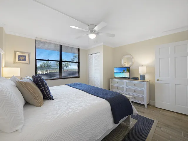 a bedroom with a large bed and a window